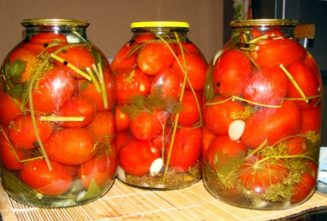 jars with tomatoes and raspberry leaves