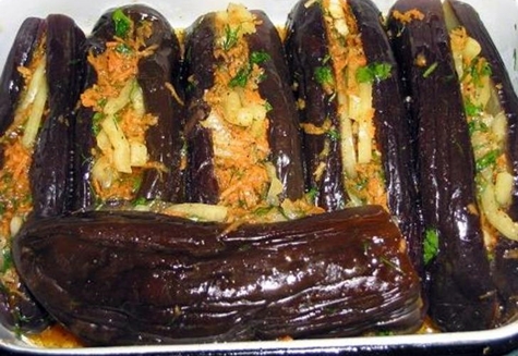 pickled eggplants with carrots, herbs and garlic in a plate