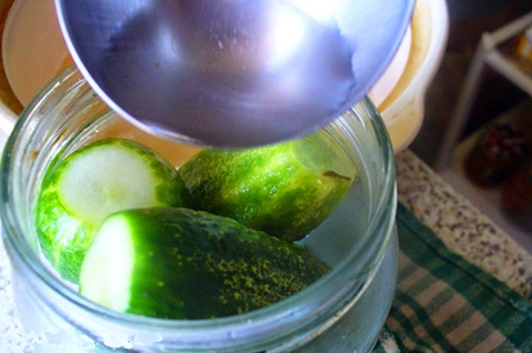 komkommers in appelsap in een pot op tafel