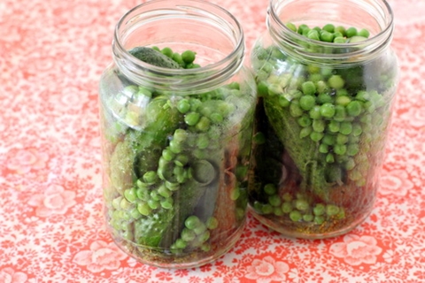 cucumbers with green peas in jars