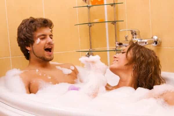 a woman and a man take a bath
