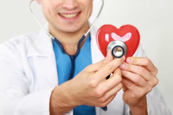 doctor with heart figurine